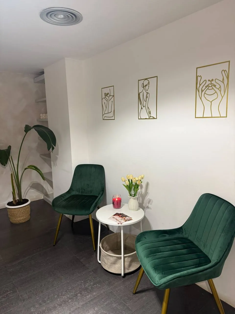 Waiting area at Nude Beauty Studio, with green armchairs