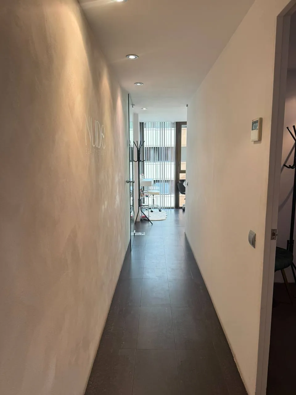 Entrance corridor with the Nude Beauty Studio logo